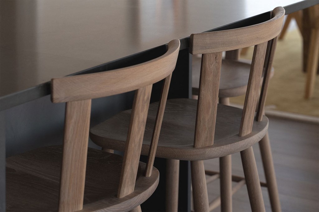 Two wooden chairs are positioned in front of a table.