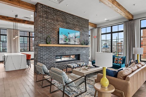 A living room with a fireplace and a painting above it.