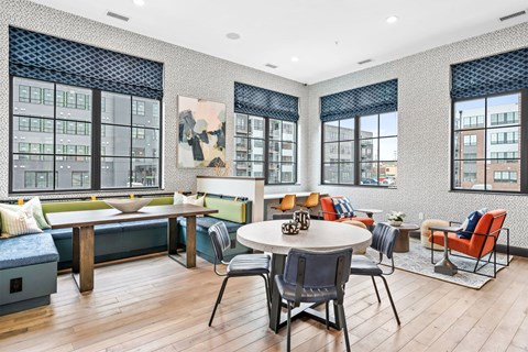 A modern living room with a large table and chairs.