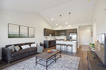 A modern living room with a grey couch and a coffee table.