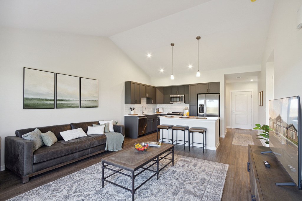 A modern living room with a grey couch and a coffee table.