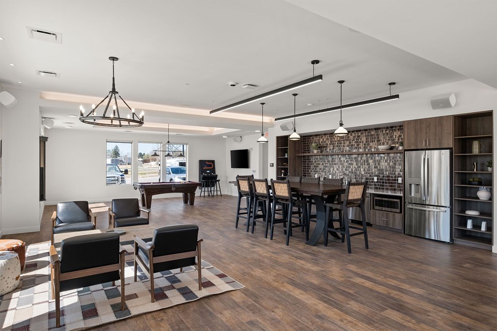 A modern kitchen with dark wood floors and a large island.