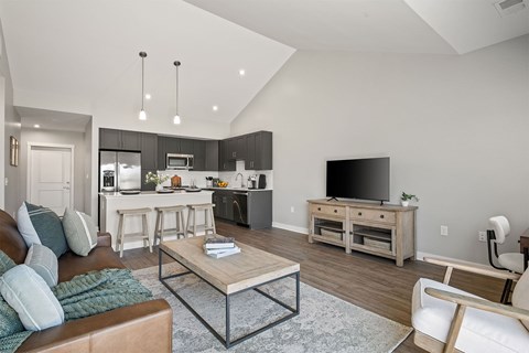 A modern living room with a brown leather couch and a wooden coffee table.
