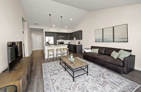A modern living room with a brown couch and a coffee table.