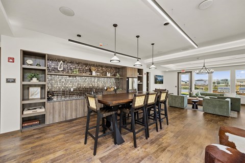A dining room with a wooden table and chairs.