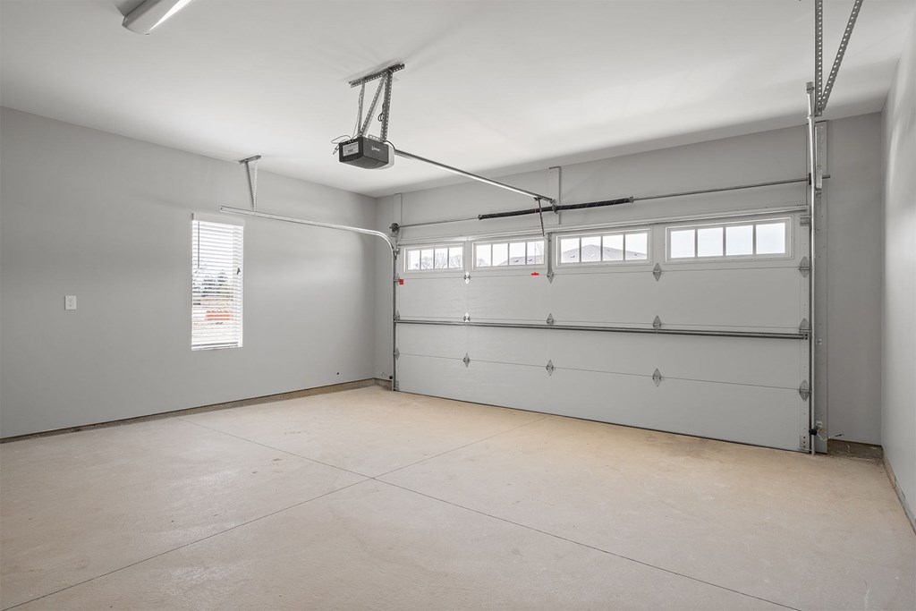 A spacious garage with a lift system installed.