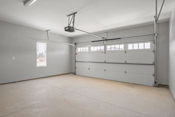 A spacious garage with a lift system installed.