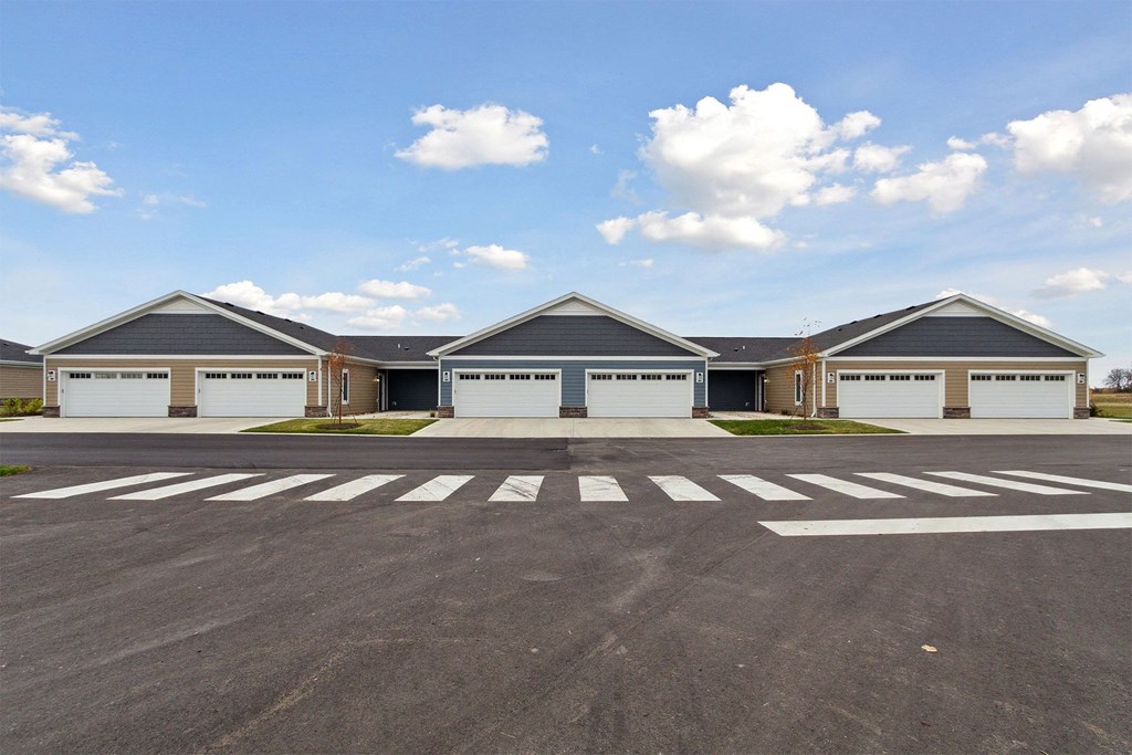an empty parking lot in front of a house