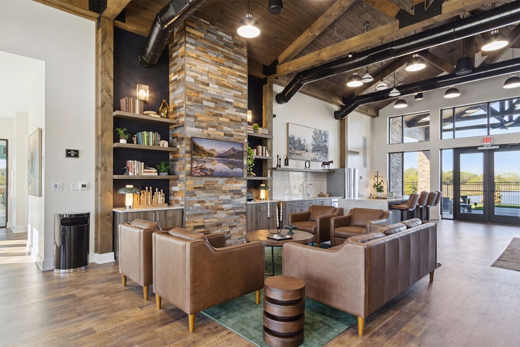 a lobby with couches and chairs and a stone fireplace