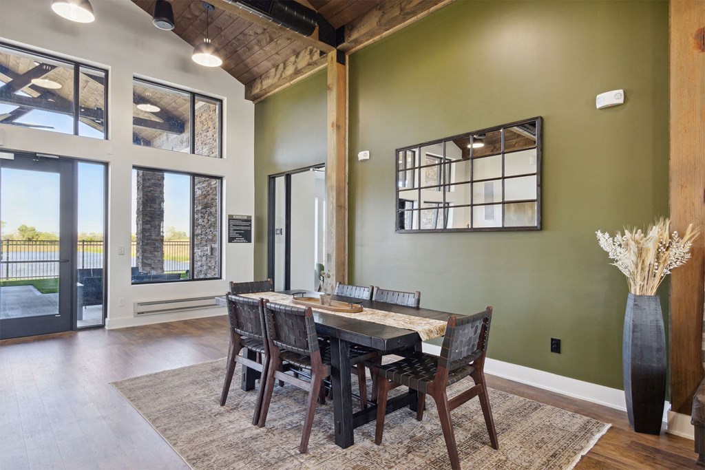 a dining room with a wooden table and chairs