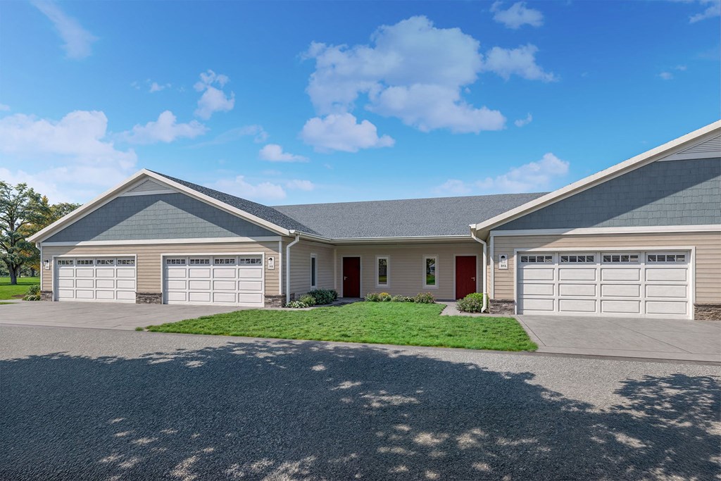 a house with two garage doors and a lawn