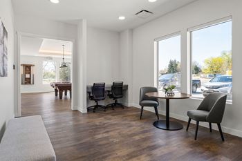 tech lounge with a table and chairs and a large window