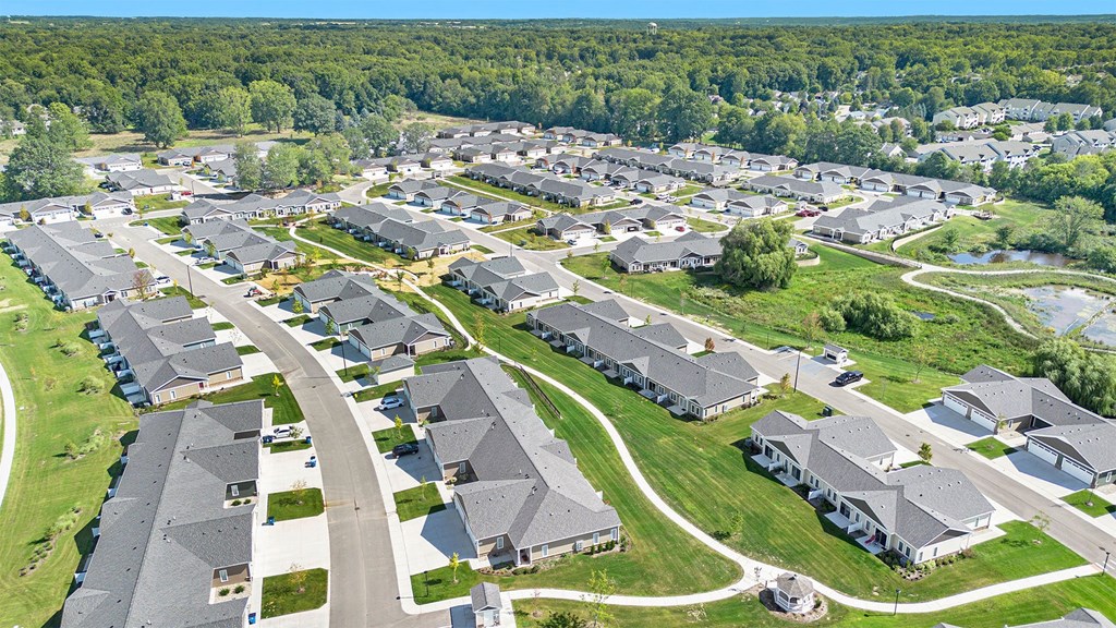 A bird's eye view of a residential area with houses and roads.