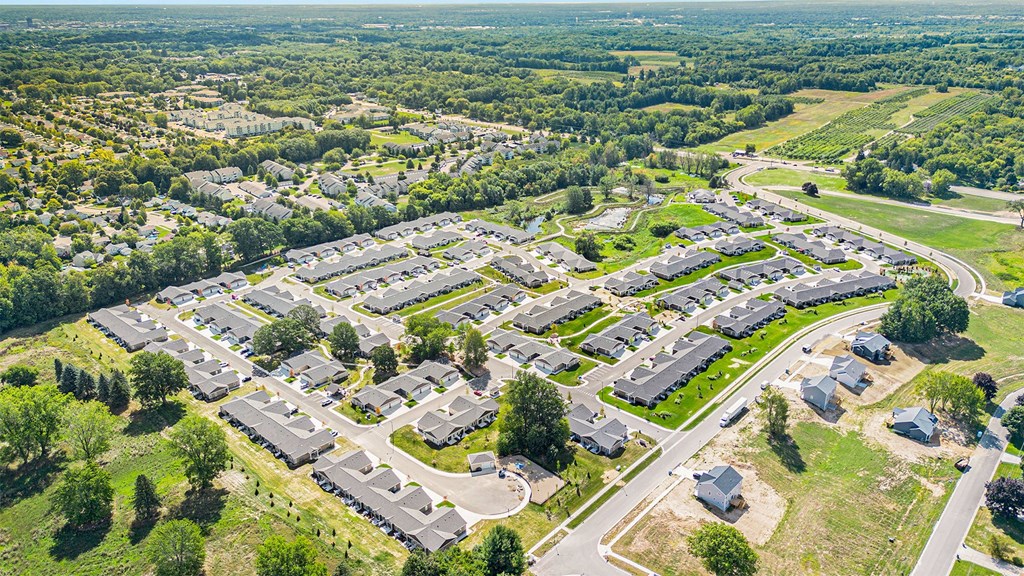 A bird's eye view of a residential area with houses and roads.