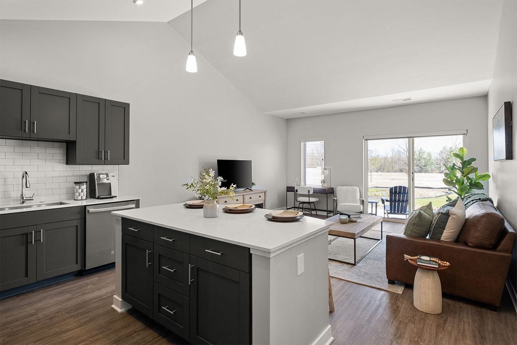 a kitchen with a center island and a living room