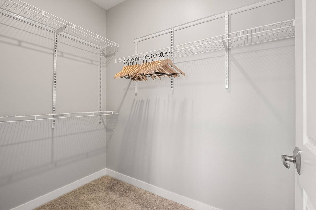 our spacious walk in closet has a large amount of hanging clothes