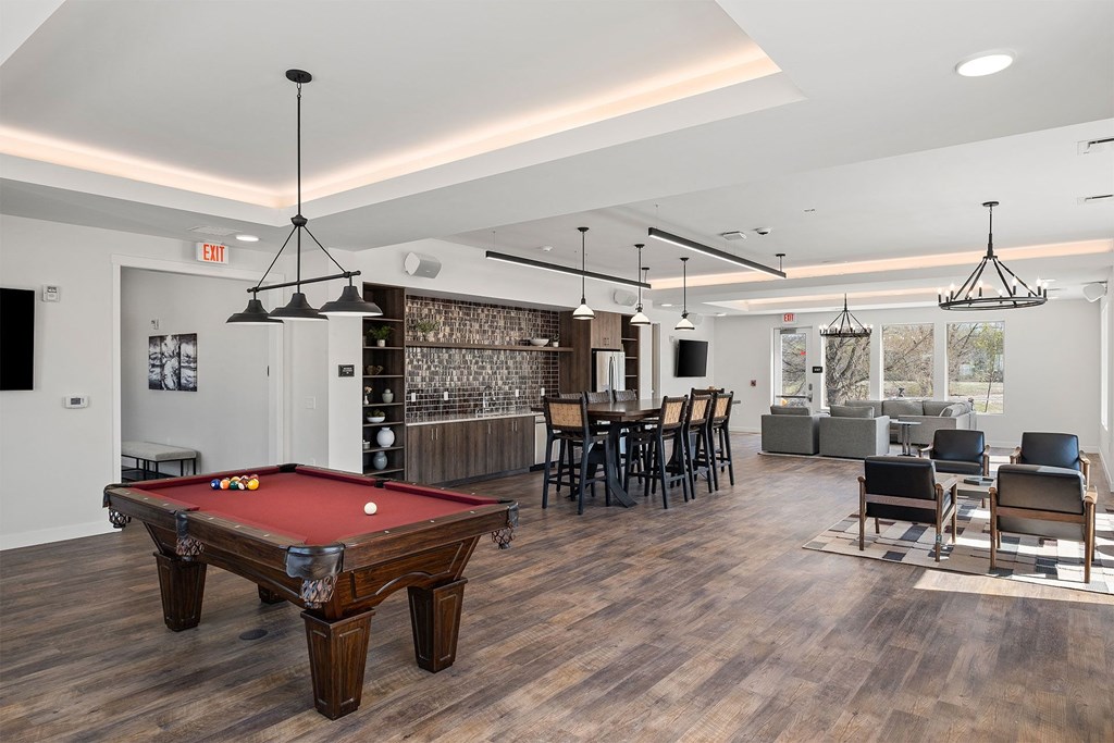 a community room with a pool table and a bar