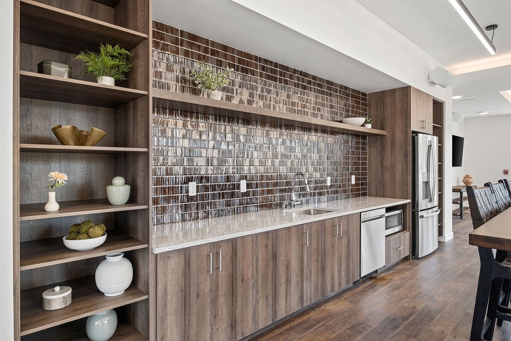 a kitchen with wooden cabinets and a counter top with a sink