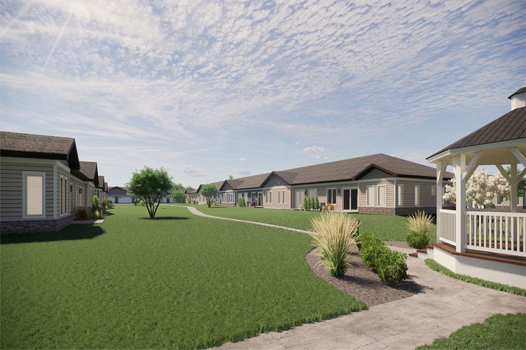 a row of houses in a yard with green grass