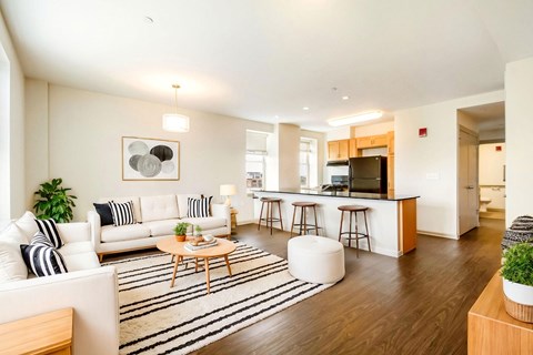 A modern living room with a white couch and a coffee table.