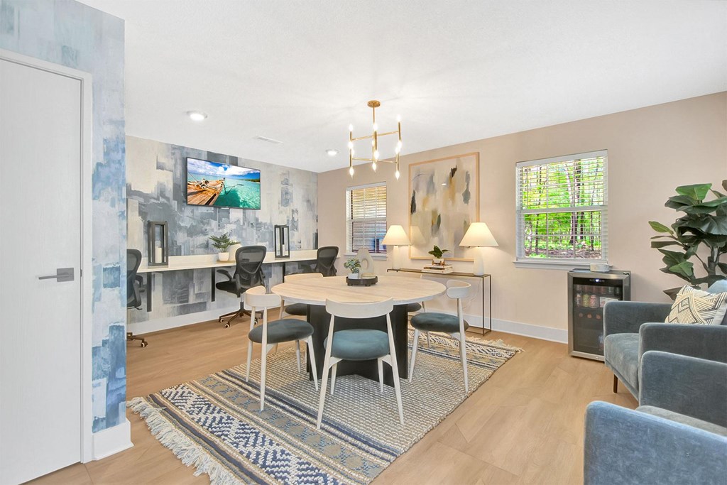 a living room with a dining room table and chairs