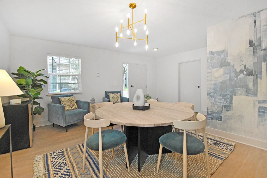 a dining room with a table and chairs and a chandelier