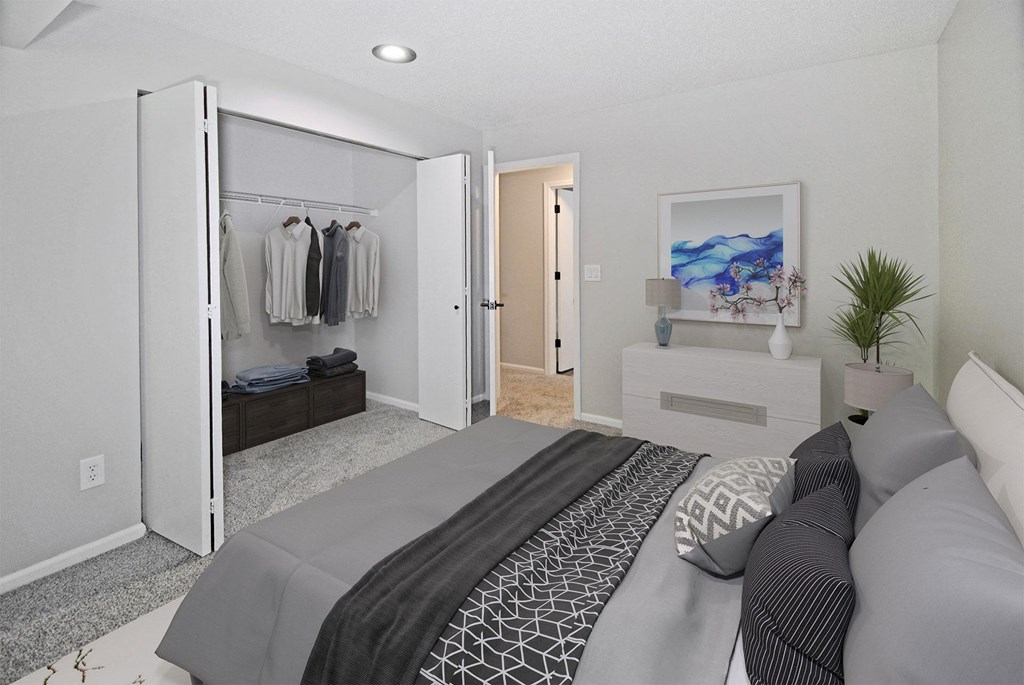 A bedroom with a large bed and a wardrobe.