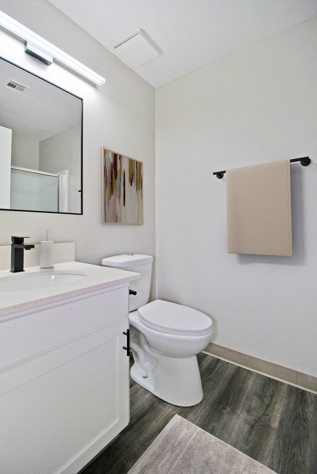 A white toilet sits next to a sink in a bathroom.