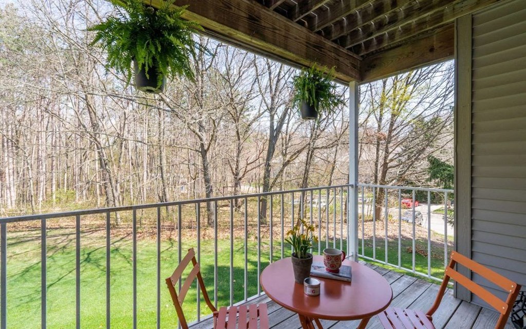 a screened in porch with a table and chairs