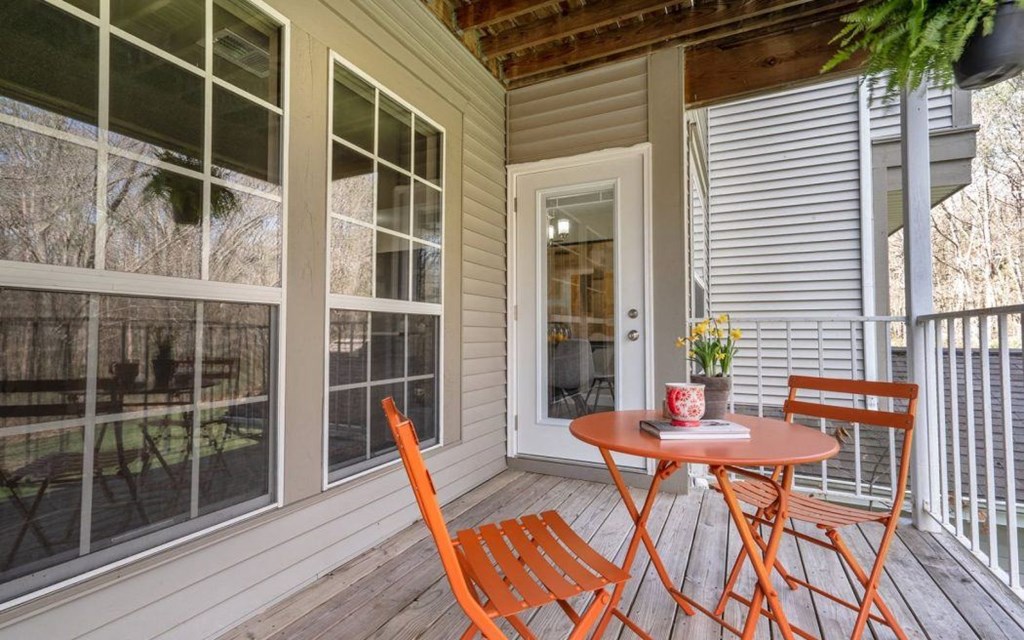 a patio with a table and chairs on a porch