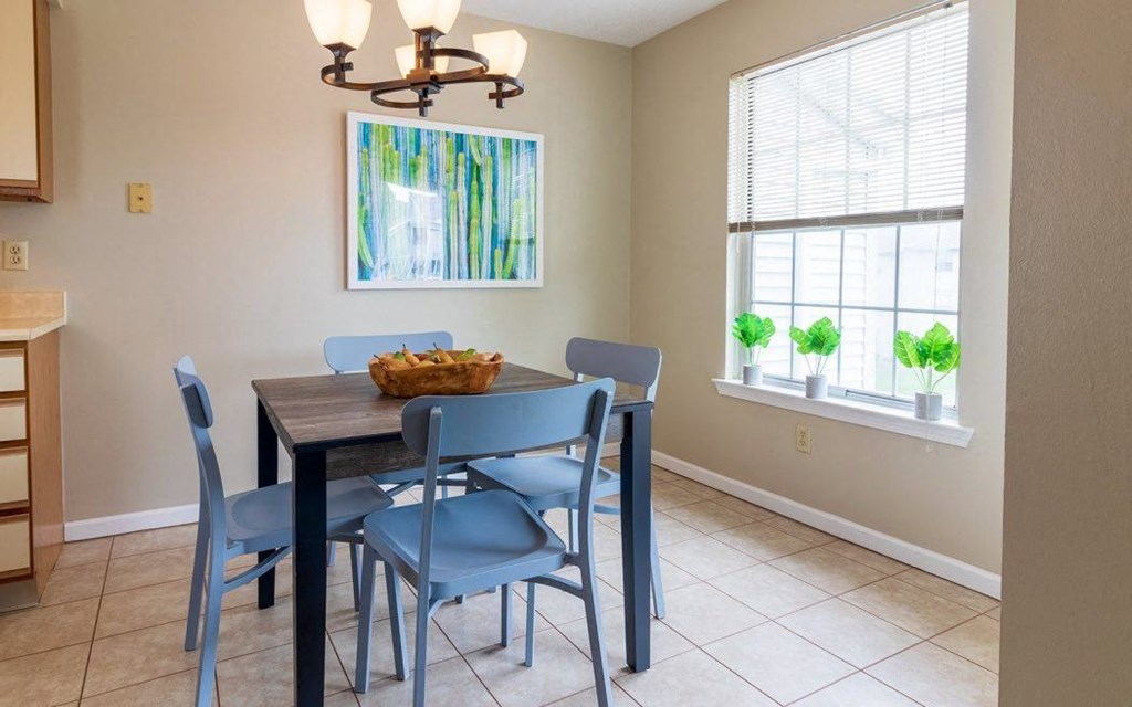 a dining room with a wooden table and blue chairs