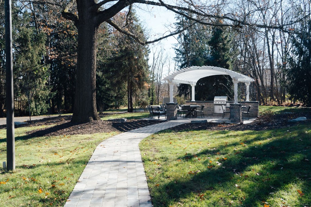 a path leading to a gazebo in a park