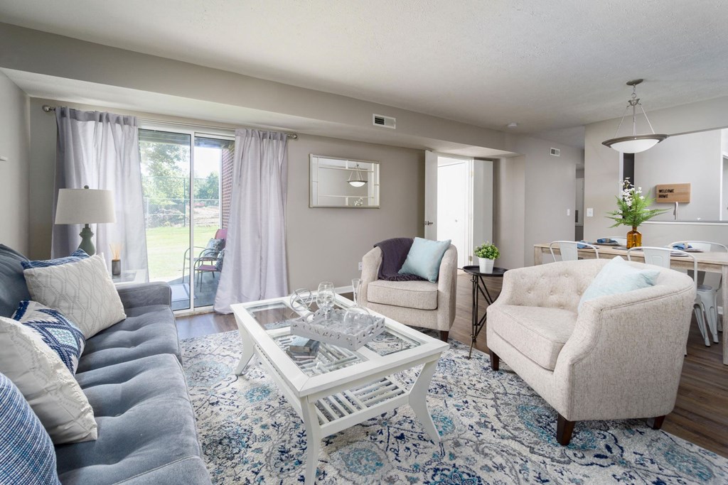 a living room with couches and chairs and a table