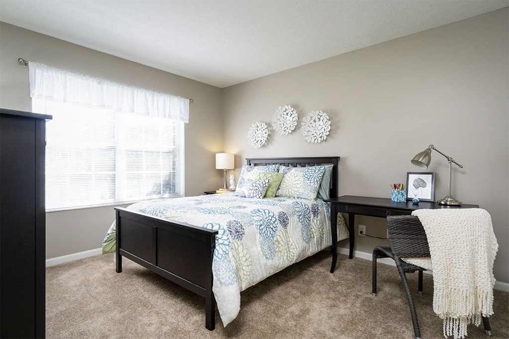 a bedroom with a bed and a desk