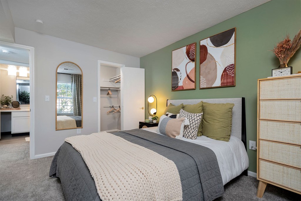 a bedroom with green walls and a bed