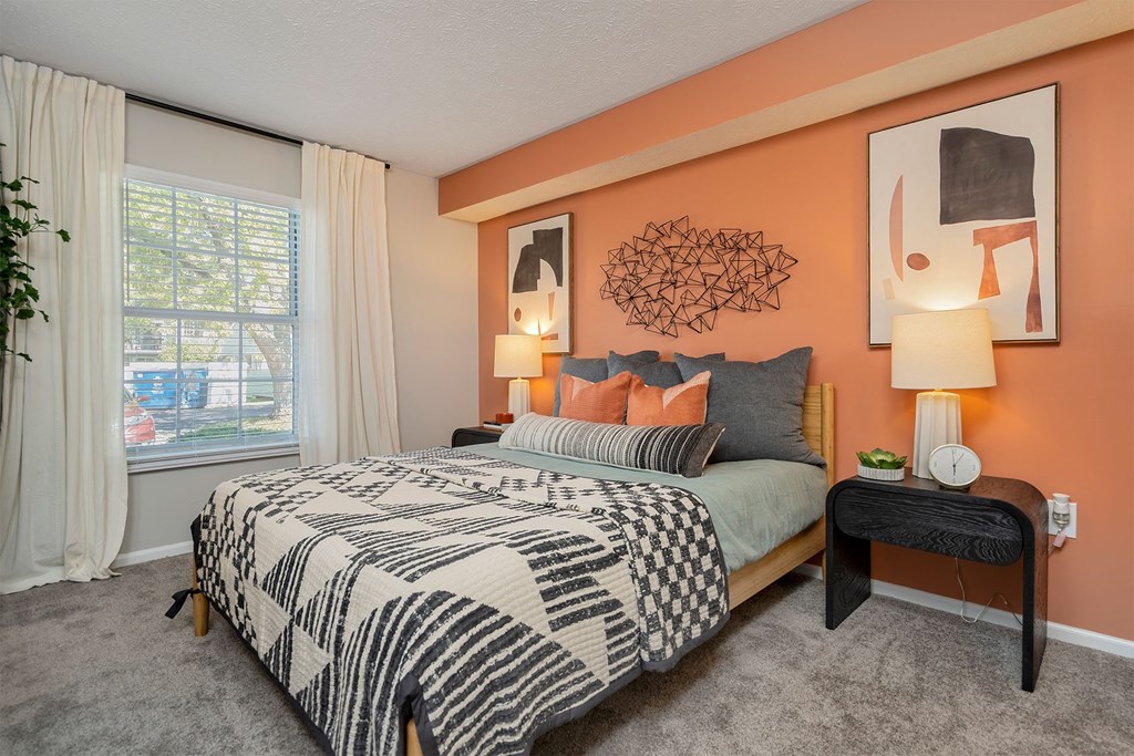 a bedroom with a bed and a window