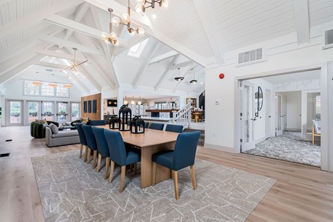 a dining room with a wooden table and blue chairs