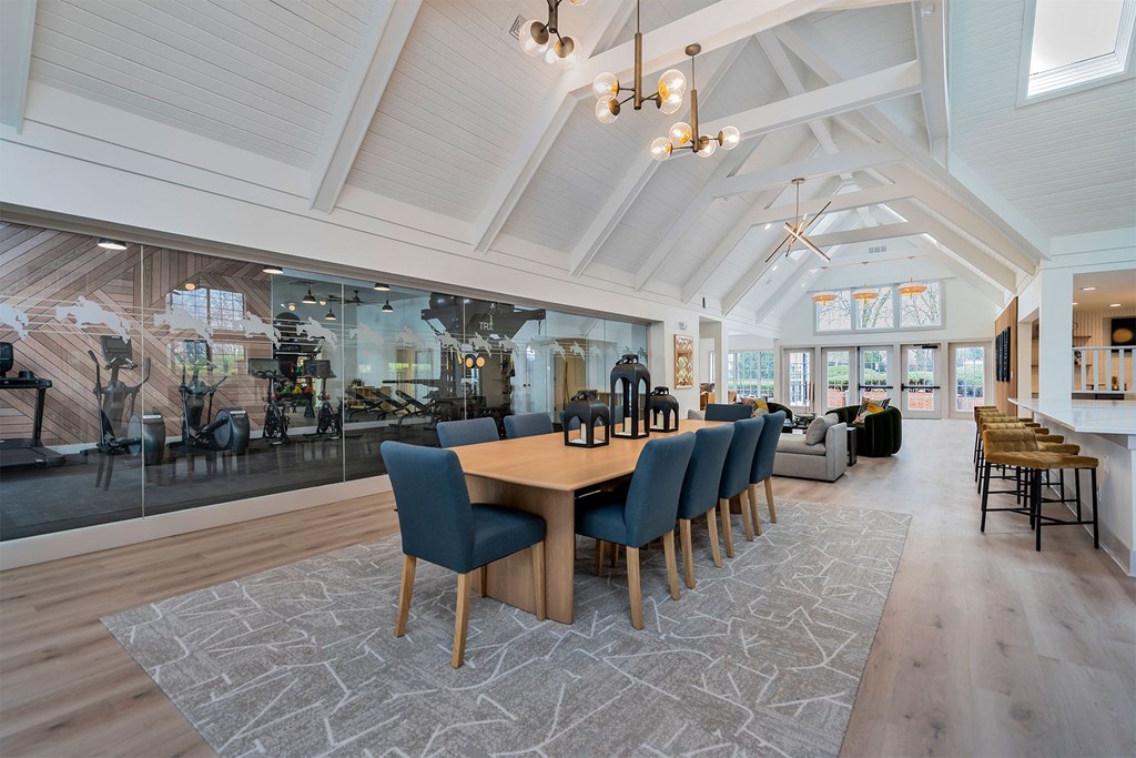 a dining room with a long wooden table and blue chairs