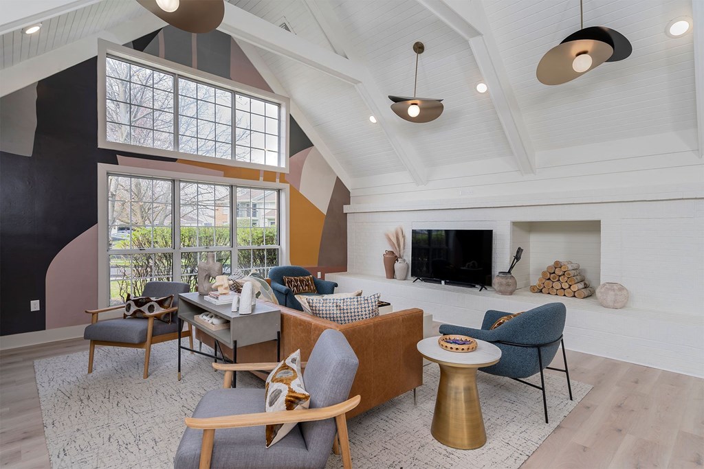 a living room with couches and chairs and a television