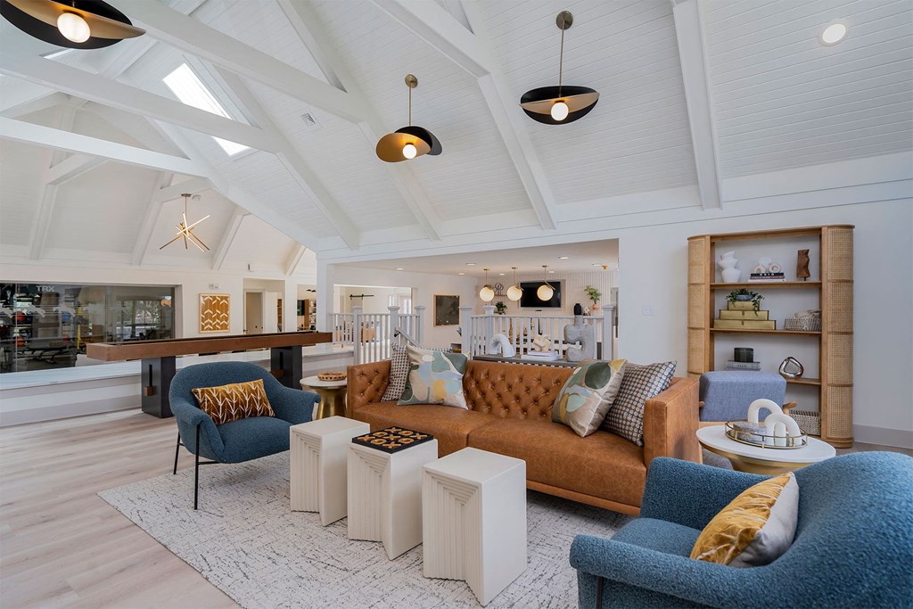 a living room with couches and chairs and a bar