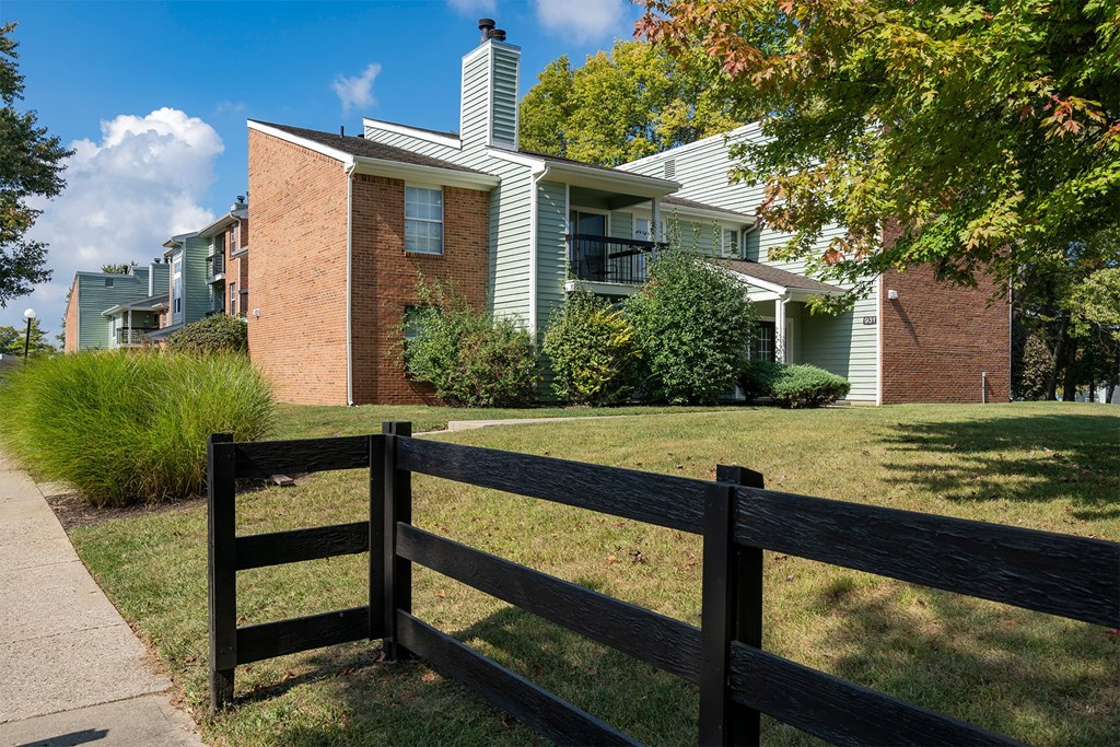 a wooden fence in front of an apartment building