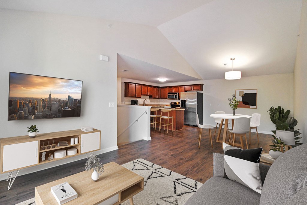 a living room with a view of a kitchen and a dining room