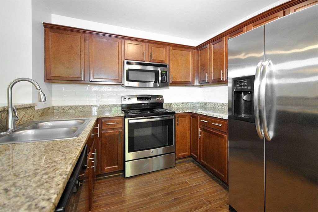 a kitchen with stainless steel appliances and granite counter tops