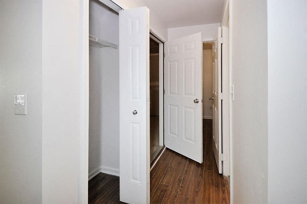a bedroom with a closet and a door open