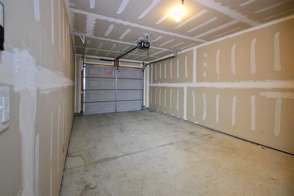 the inside of a garage with a garage door