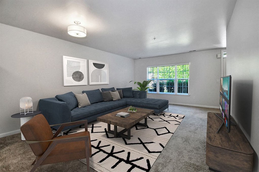 a living room with a blue couch and a table