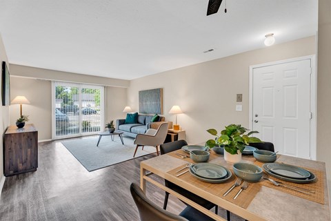 A dining room with a table set for four.