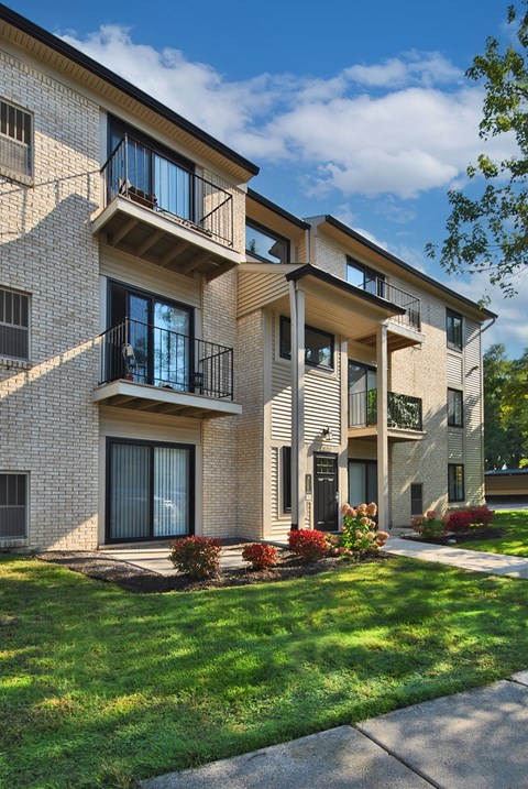 A modern apartment building with balconies and windows.