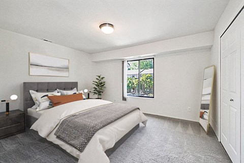 A bedroom with a large bed and a window overlooking a garden.