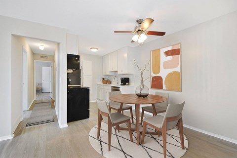 A dining room with a table set for four.
